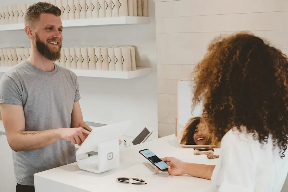 Shop owner serving a customer at a store counter